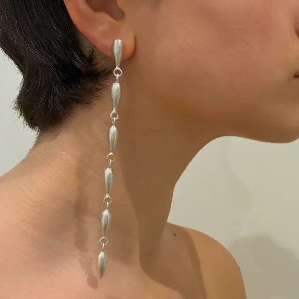 Cry Me A Lot silver earrings worn on ears
