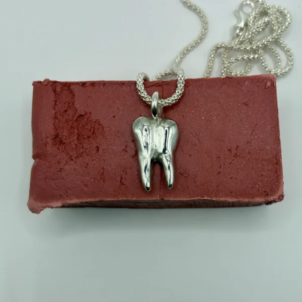 Tooth Charm silver pendant, front view