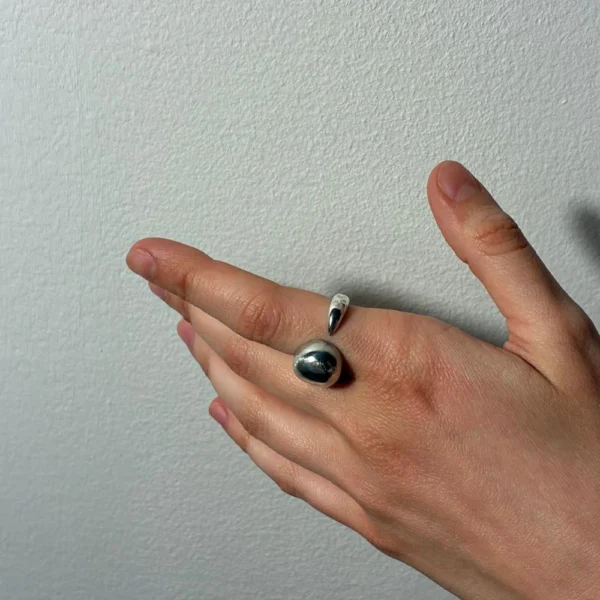 Uprooted silver ring, worn on hand